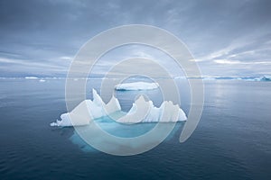 Iceberg at sunset. Nature and landscapes of Greenland. Disko bay. West Greenland. Summer Midnight Sun and icebergs.