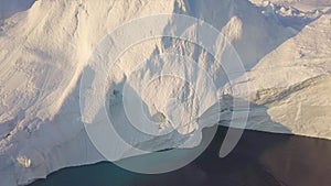 Iceberg at sunset. Nature and landscapes of Greenland. Disko bay. West Greenland. Summer Midnight Sun and icebergs. Big blue ice