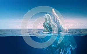 Iceberg under blue sky with underwater part and water line