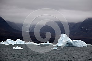 Iceberg under dramatic sky in Disko Bay, Arctic, Greenland, Denmark photo