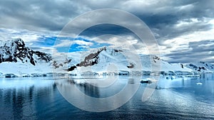 Icebergs in Antarctica and a dramatic sky