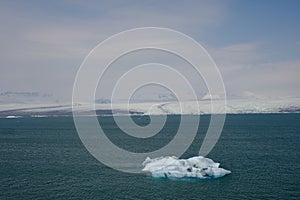 Icebergs calved off the glacier slowly flow out to the ocean from the lagoon