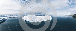 Icebergs drone aerial image top view - Climate Change and Global Warming. Icebergs from melting glacier in icefjord in