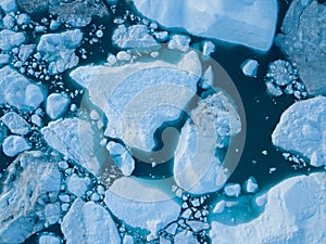 Icebergs drone aerial image top view - Climate Change and Global Warming. Icebergs from melting glacier in icefjord in Ilulissat.