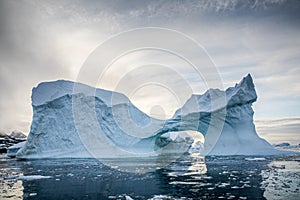 Icebergs floating in Antarctica waters in midnight sun