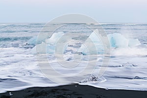 Icebergs floating and melting in arctic ocean. Pieces of ice drifted out of Jokulsarlon lagoon, Iceland