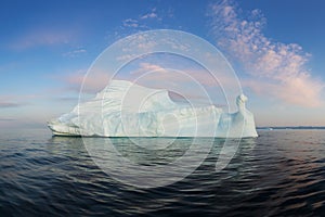 Icebergs in front of the fishing town Ilulissat in Greenland. Nature and landscapes of Greenland. Travel on the vessel among ices.