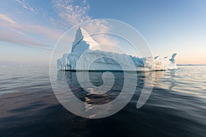 Icebergs in front of the fishing town Ilulissat in Greenland. Nature and landscapes of Greenland. Travel on the vessel among ices.