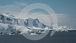Icebergs and glaciers in Antarctica. Landscape of snowy mountains and icy shores in Antarctica. Beautiful blue iceberg