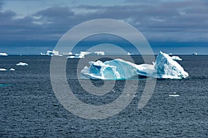 Icebergs in iceberg graveyard in Fjord, Greenland. Different icebergs broken from glaciers in Greenland.