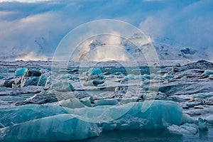 Icebergs and snowy mountains on the Jokulsarlon lagoon in south Iceland