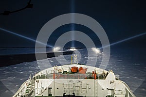 Icebreaker ship cruising at night in the polar seas