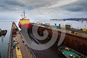 Icebreaker ship enters floating dock for repairs, maritime industry maintenance in dockyard. Marine transportation