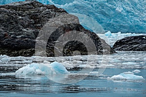 Iceburgs, ice chunks and sea stack rock formations in Aialik Bay