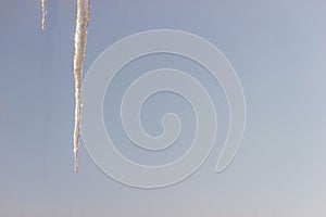 Icecle on a background of blue sky