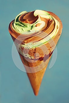 Icecream cone with chocolate and pistachio icecream