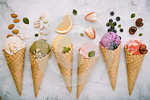 Icecreams with fruit and nut ingredients - colorful ice cream with cones on a white background