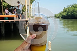 Iced Americano with fresh orange juice served at riverside cafe