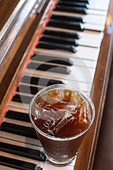 Iced americano on old piano