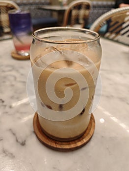 Iced Caffee Latte on Marble Table with Elegant Cafe Ambiance