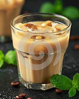 Iced caramel coffee in a glass with cold milk. Summer drink