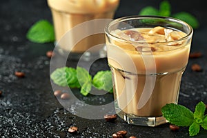 Iced caramel coffee in a glass with cold milk. Summer drink