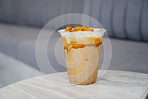 Iced caramel coffee topped with crispy dalgona coffee.