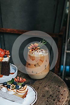 Iced caramel latte coffee with syrup and whipped cream decorate with flower.