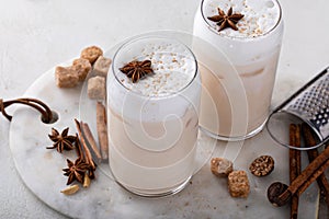 Iced chai latte with warm winter spices topped with milk foam