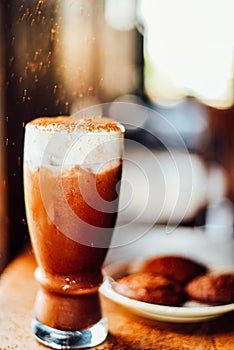 Iced cocoa drink  with whipped cream and Brownie cookies on wood table