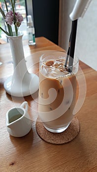 iced coffee capucinno with flower vase and sugar