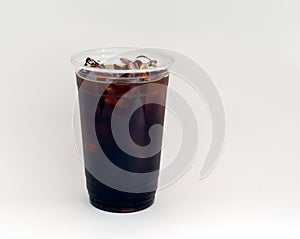 Iced coffee or Cold Brew coffee in a clear plastic cup.