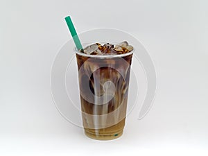 Iced coffee or Cold Brew coffee with cream in a clear plastic cup.