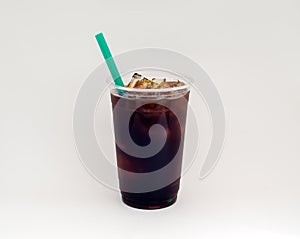 Iced coffee or Cold Brew coffee with a green straw on a white background.