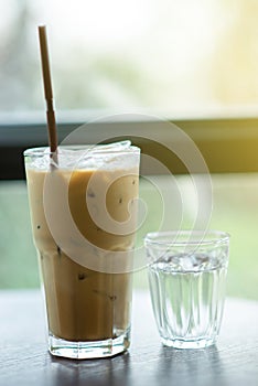 Iced coffee and cold water placed on the table