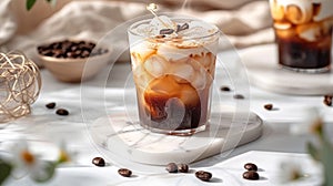 Iced coffee with cream and sugar on marble table. Coffee beans scattered on the table