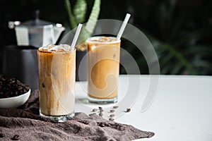 Iced of coffee cup on glass cup and beans coffee , mokacoffee pot place on white table copy space foryour text