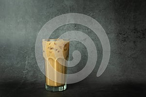 Iced of coffee cup on glass cup on black background. Copy space your text