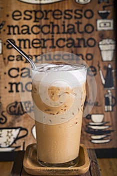 iced coffee drink with coffee menu board as background