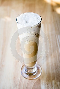 Iced coffee frappe on a table with a wood background
