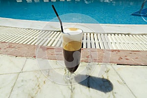 Iced coffee freddo cappuccino by the pool.