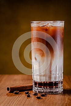 Iced coffee with ice. Frappe, frappuccino with cream and cinnamon on wooden table. copy space