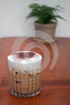 Iced coffee with micro foam in coffee shop