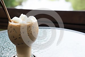 iced coffee or mocha drink in the glass on table at cafe