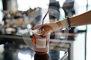 Iced coffee with orange - A plastic glass of americano mixed with craft soda and yuzu orange juice.