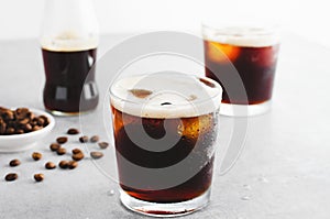 Iced Coffee, Sparkling or Cold Brew Coffee with Ice on Bright Background, Coffee Cocktail, Refreshing Beverage