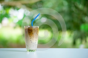 Iced coffee on white table. Cold beverage in summer