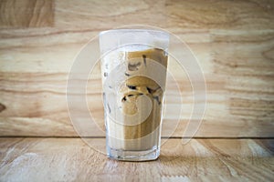 Iced coffee on a wood table with a wood background