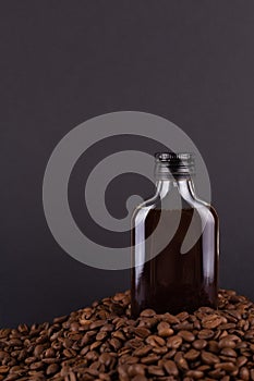 Iced cold brew coffee in bottle mockup on a mountain of roasted coffee beans. in blank label bottle. Copyspace