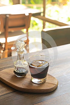 Iced cold brew coffee on wood tray